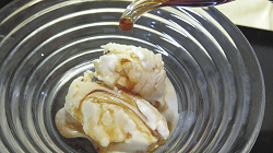 Soy sauce is poured over ice cream.